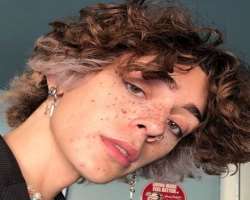 He has piercing in his nose and ears.